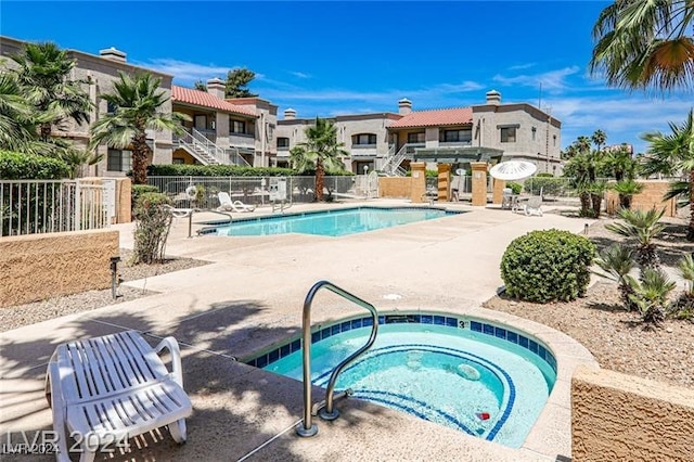 view of pool featuring a patio area and a hot tub