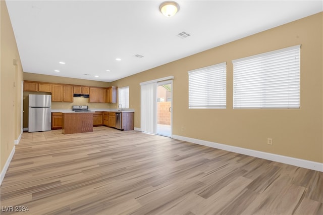 kitchen featuring light hardwood / wood-style floors, stainless steel appliances, and extractor fan