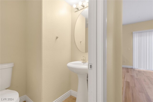 bathroom with sink, wood-type flooring, and toilet