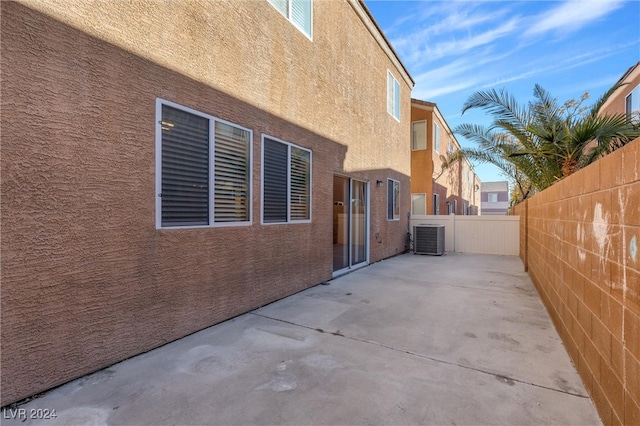 view of side of home with a patio and cooling unit