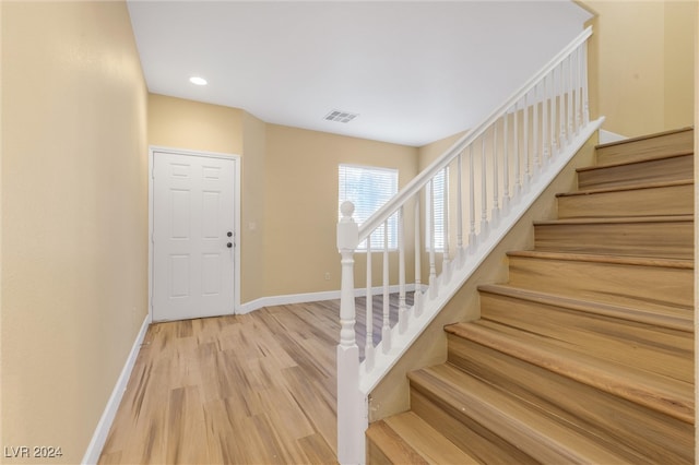 stairway featuring wood-type flooring