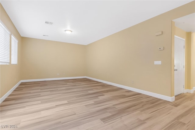 unfurnished room with light hardwood / wood-style floors