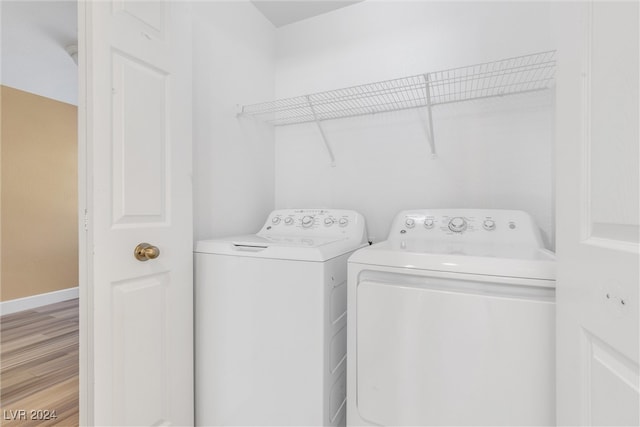 laundry area featuring light hardwood / wood-style flooring and washer and dryer