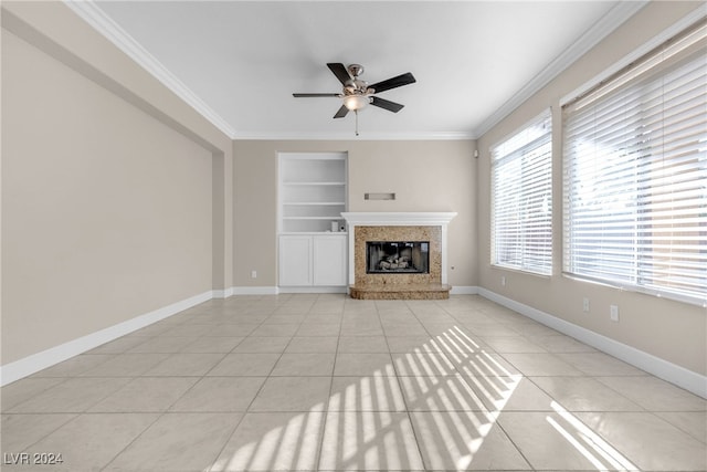 unfurnished living room featuring light tile patterned floors, built in shelves, and ornamental molding