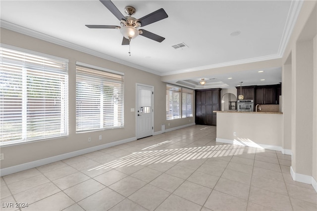 unfurnished living room featuring light tile patterned floors, plenty of natural light, ornamental molding, and ceiling fan