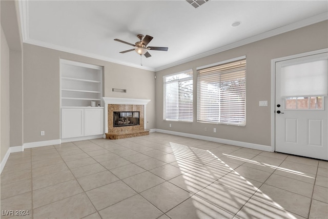 unfurnished living room with built in features, crown molding, and light tile patterned floors