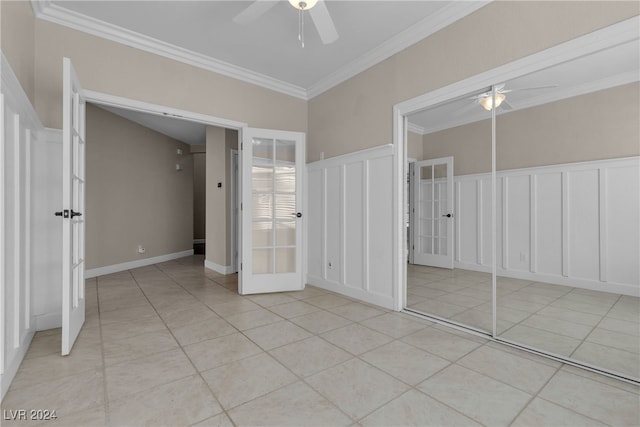 unfurnished bedroom featuring ceiling fan, french doors, a closet, light tile patterned flooring, and ornamental molding