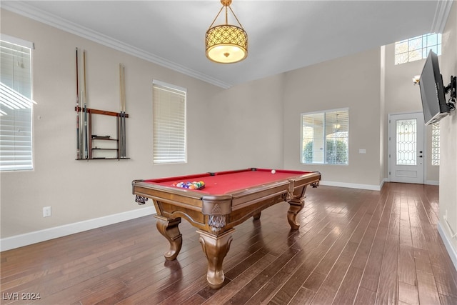 game room featuring a healthy amount of sunlight, dark hardwood / wood-style flooring, crown molding, and billiards