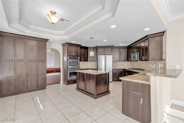 kitchen featuring sink, hanging light fixtures, dark brown cabinets, and appliances with stainless steel finishes