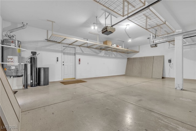 garage with strapped water heater and a garage door opener