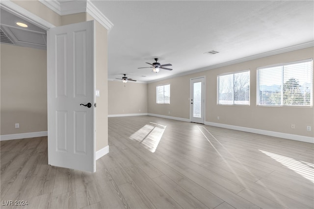 empty room featuring ceiling fan, ornamental molding, and light wood-type flooring