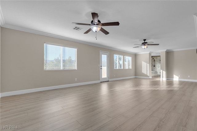 spare room with crown molding, light hardwood / wood-style flooring, and a healthy amount of sunlight