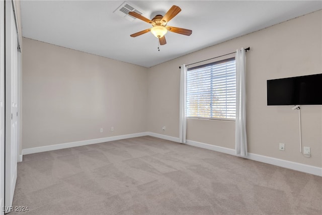 carpeted spare room with ceiling fan