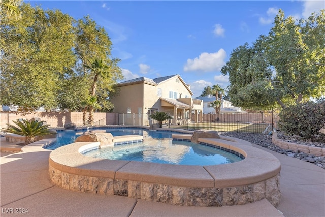 view of swimming pool featuring an in ground hot tub