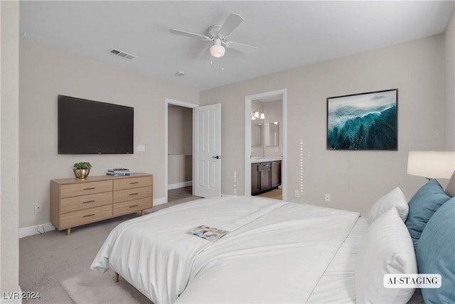 carpeted bedroom with ceiling fan and ensuite bathroom