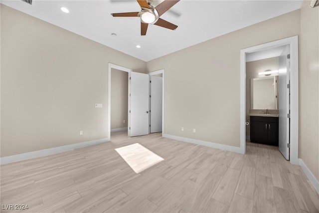 unfurnished bedroom featuring ensuite bath, ceiling fan, sink, and light hardwood / wood-style flooring