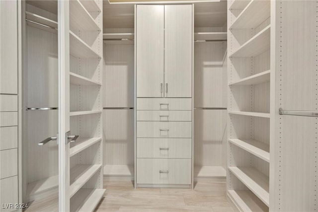 walk in closet featuring light hardwood / wood-style flooring