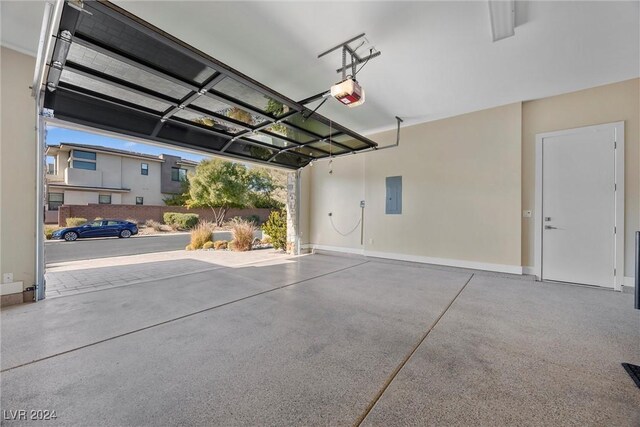 garage with electric panel and a garage door opener