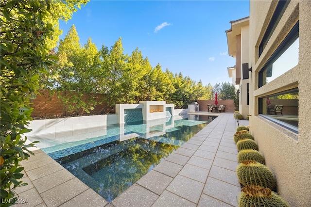 view of swimming pool featuring an in ground hot tub