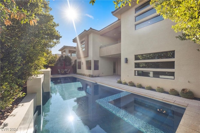 view of swimming pool with an in ground hot tub and a patio