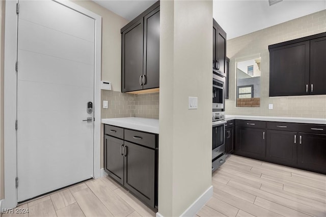 kitchen featuring dark brown cabinets, light hardwood / wood-style flooring, and tasteful backsplash