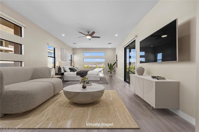 living room with hardwood / wood-style flooring and ceiling fan