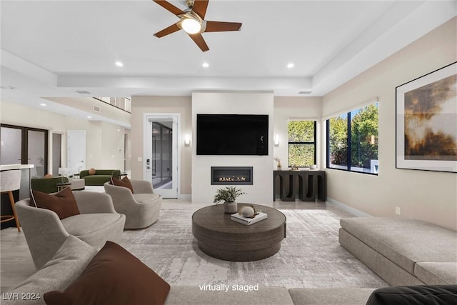 living room with light wood-type flooring and ceiling fan