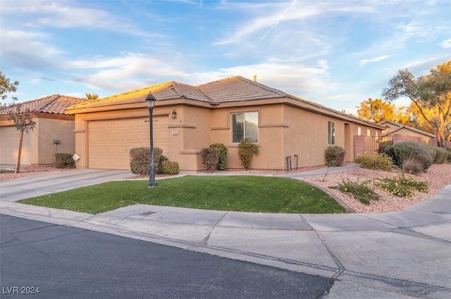 view of front facade featuring a garage and a front lawn