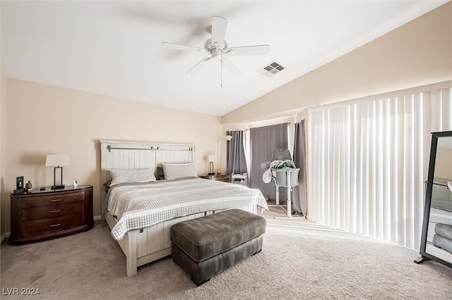 bedroom featuring ceiling fan, light colored carpet, and lofted ceiling