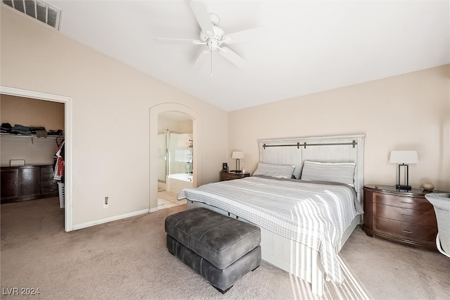 carpeted bedroom featuring a closet, ensuite bath, a spacious closet, and ceiling fan