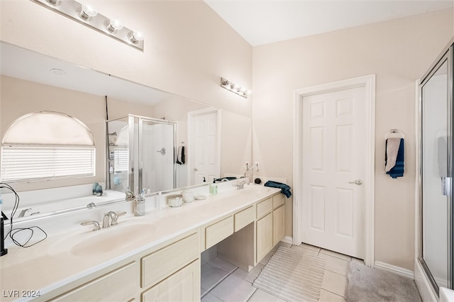 bathroom featuring tile patterned flooring, vanity, and a shower with shower door