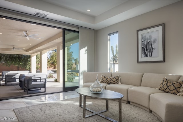 living room with a wealth of natural light and ceiling fan