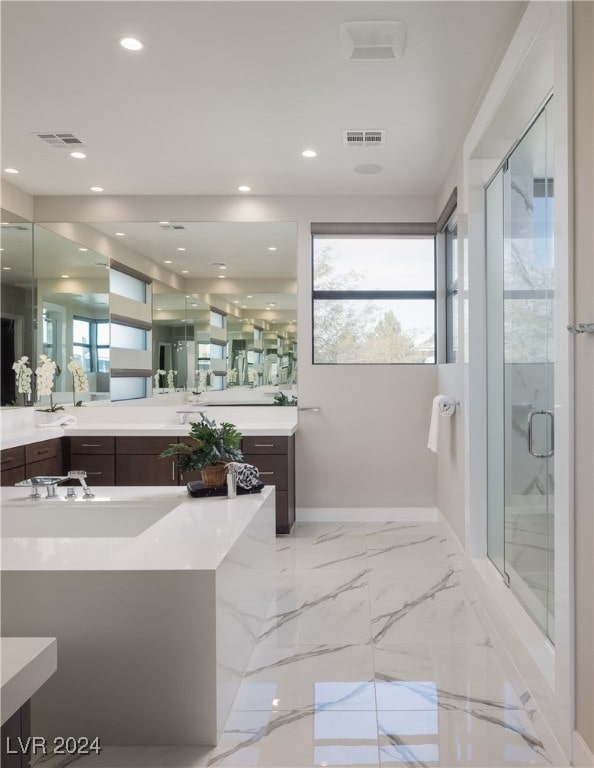 bathroom featuring a shower with door and vanity