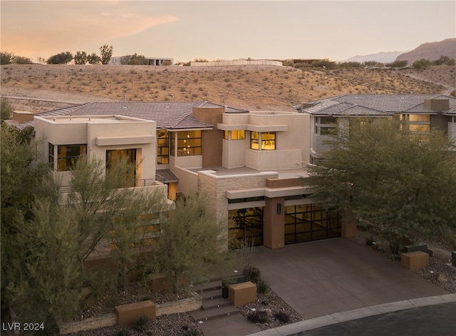 adobe home with a mountain view and a garage