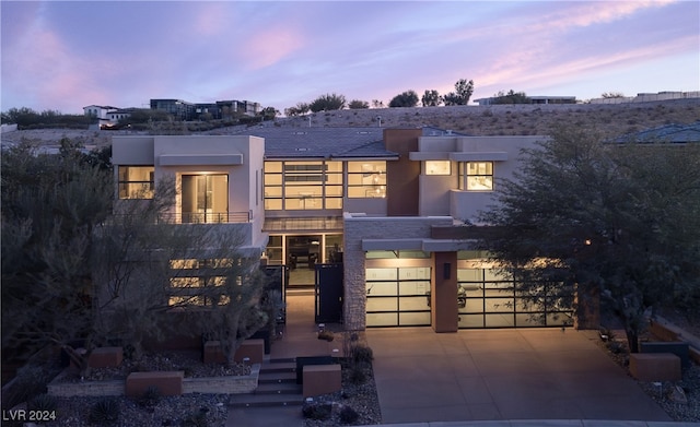 view of front of house featuring a balcony and a garage