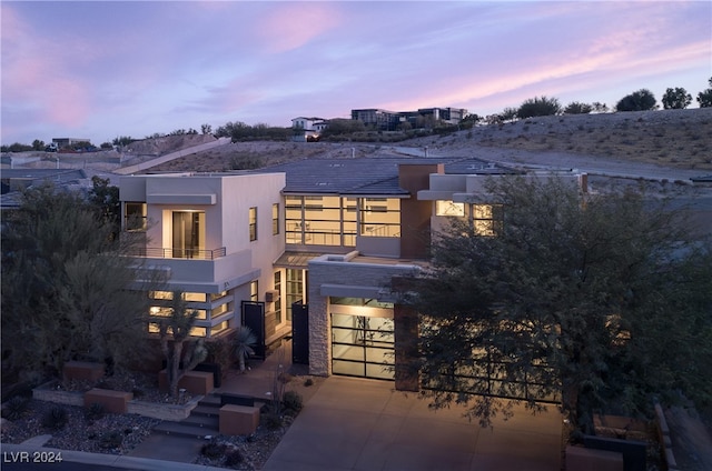 modern home featuring a balcony and a garage