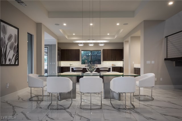 dining area featuring a tray ceiling