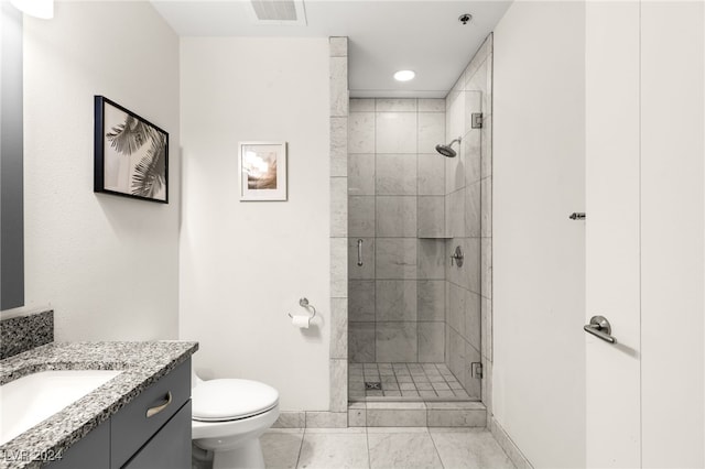 bathroom featuring tile patterned flooring, a shower with door, vanity, and toilet