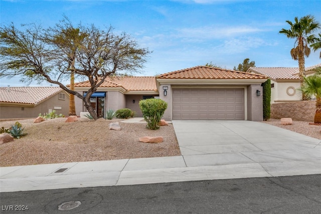 mediterranean / spanish-style home with a garage