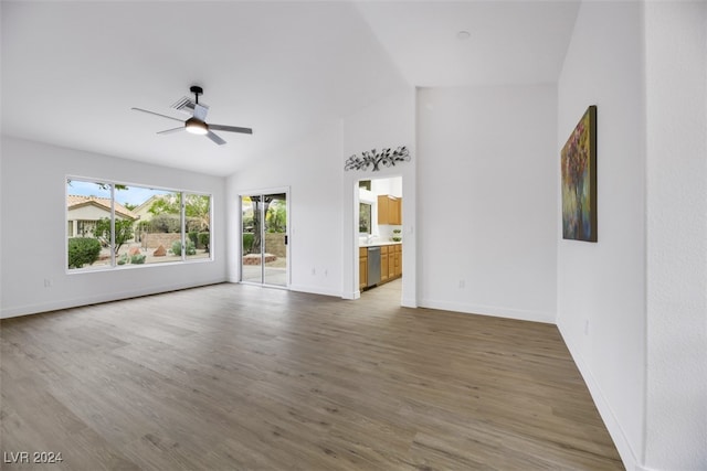 unfurnished living room featuring ceiling fan, lofted ceiling, and dark wood-type flooring