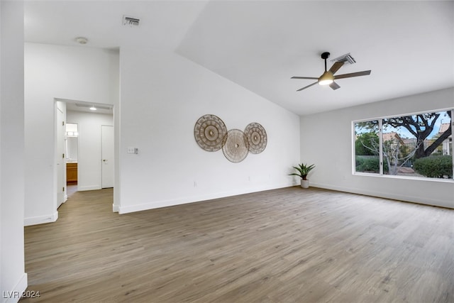 unfurnished room with hardwood / wood-style floors, ceiling fan, and vaulted ceiling