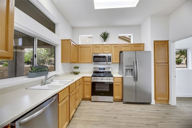 kitchen featuring light hardwood / wood-style floors, light brown cabinetry, sink, and appliances with stainless steel finishes