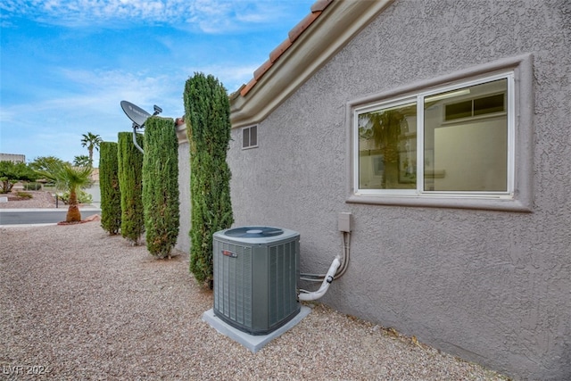 view of side of property featuring central air condition unit