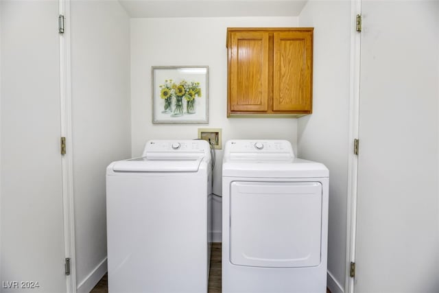 washroom featuring cabinets, dark hardwood / wood-style floors, and independent washer and dryer