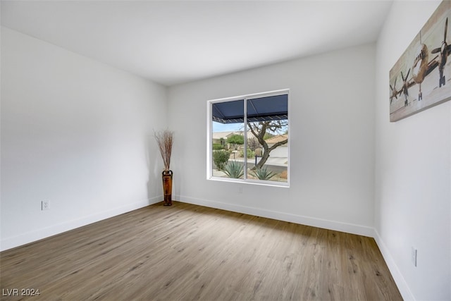 empty room with hardwood / wood-style floors