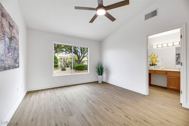 interior space featuring ceiling fan, built in desk, high vaulted ceiling, and light hardwood / wood-style floors