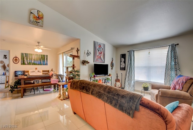 tiled living room with ceiling fan and lofted ceiling