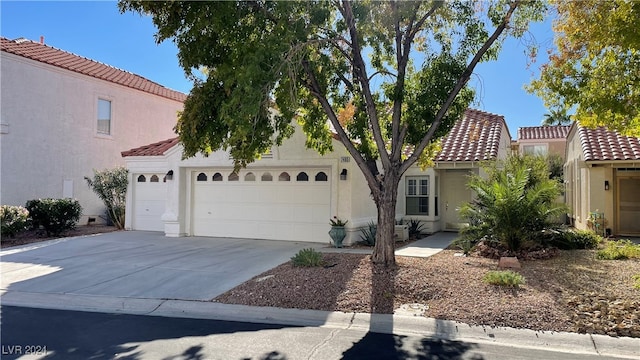 mediterranean / spanish-style home with a garage