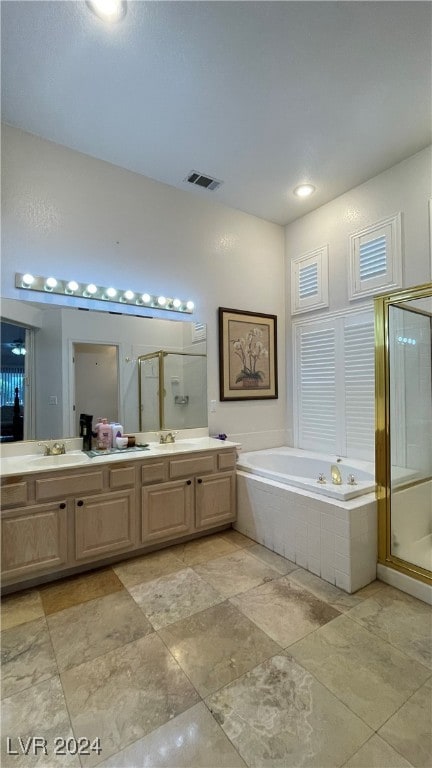 bathroom with vanity and independent shower and bath