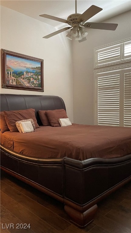 bedroom with ceiling fan and dark wood-type flooring